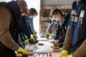 Sandia National Laboratories employees in California sand 2x4's as part of a project to build beds for the organization Sleep in Heavenly Peace. (Photo by Spencer Toy) Click on the thumbnail for a high-resolution image.