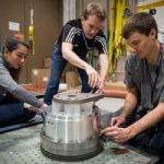 scientists work on vibration test equipment