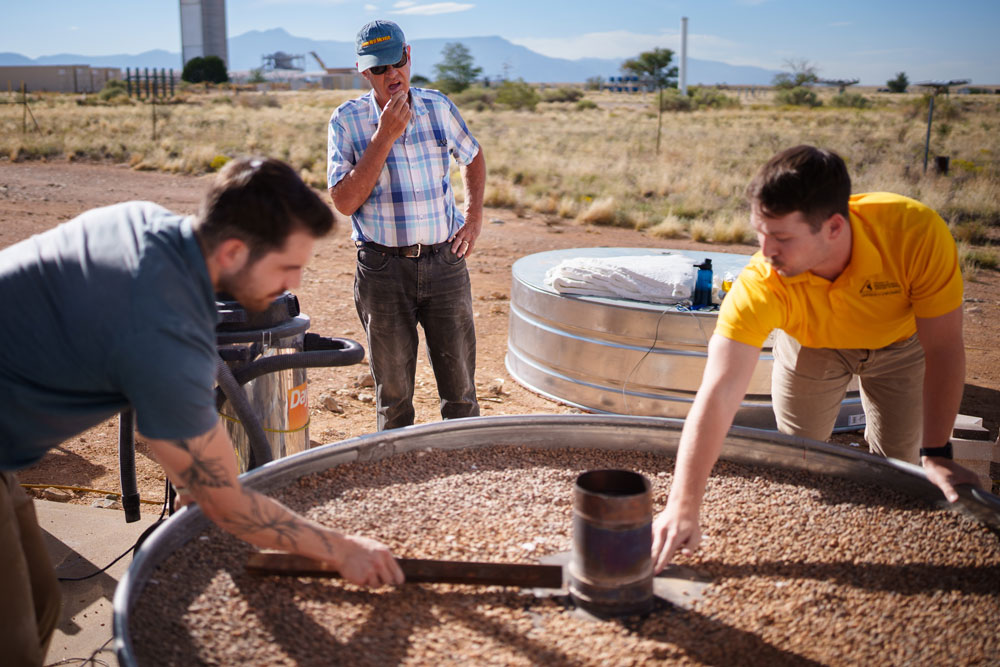 TEST TIME — Sandia mechanical engineers Nathan Schroeder, left, and Luke McLaughlin, right, discuss the design of a thermal energy storage system with CSolPower co-founder Walter Gerstle, center. Sandia is testing CSolPower’s thermal energy storage system at the National Solar Thermal Test Facility. (Photo by Craig Fritz)