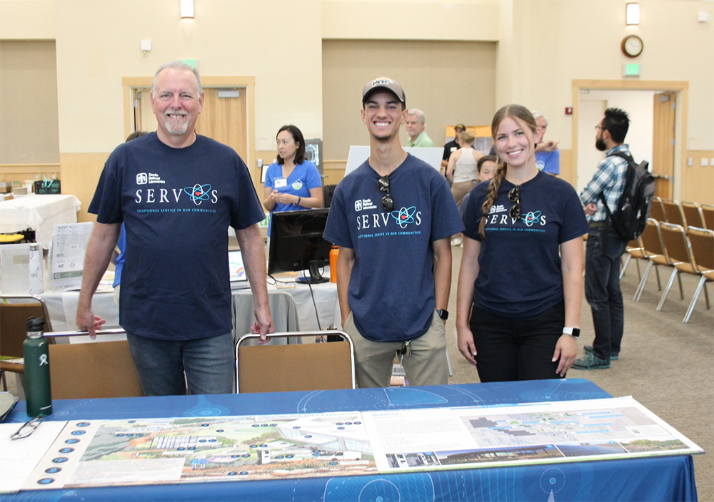 NET ZERO — Howard Royer, left, the leader of Sandia California’s net-zero effort, showcases the site’s net-zero plan with Sandians Michael Shaikh and Kylie Johnson to help Livermore Youth Climate Summit attendees learn about climate resilience efforts. (Photo courtesy Quest Science Center)