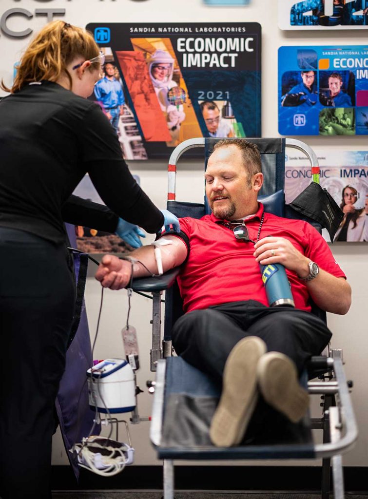 LIFE-SAVING DONATIONS — In a photo from last year’s blood drive, Scott Charles has his blood drawn by donor care tech Madi Duncan. (Photo by Craig Fritz)