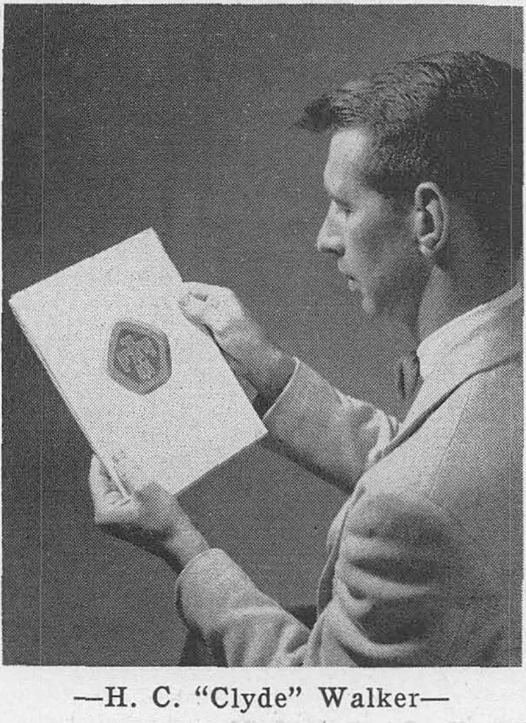 ENDURING DESIGN — A photo published in Lab News in 1955 shows Clyde Walker looking at the winning design he submitted for a service pin contest, featuring the Thunderbird. During his career, Walker saw that design eventually morph into Sandia’s logo. The Thunderbird has only undergone one major redesign, which was in the early 1970s. (Photo from the Lab News archives)