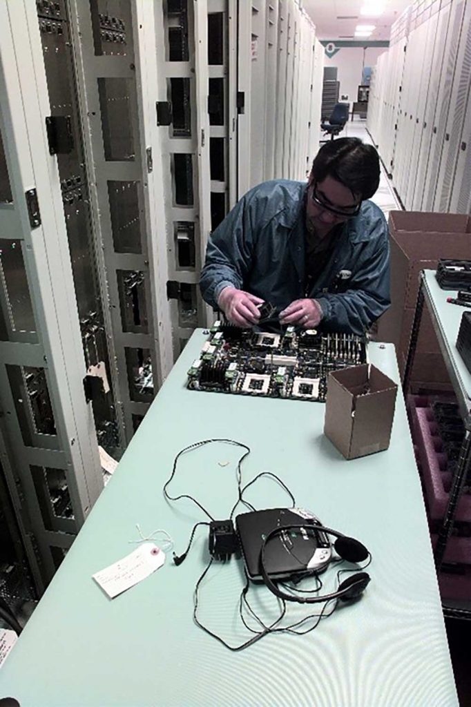 THE MOTHERBOARD — In a 1999 photo, a technician installs a processor on the Accelerated Simulation and Computing Initiative Red motherboard. (Photo from the Lab News archives)