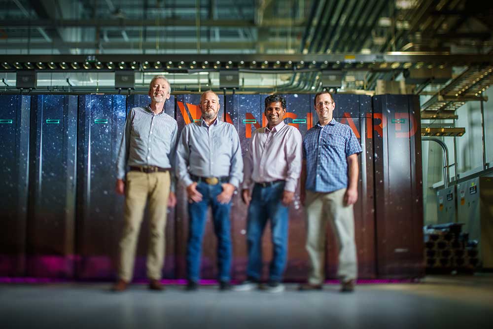 SANDIA GORDON BELL TEAM — From left, Aidan Thompson, James Laros, Sivasankaran Rajamanickam and Stan Moore, posing in front of Vanguard supercomputer, have been nominated for the Gordon Bell Prize. (Photo by Craig Fritz)