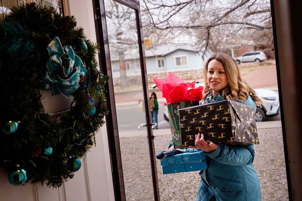 SPECIAL DELIVERY — Sunny Holmes, Saranam community engagement coordinator, helps Sandia manager Elizabeth Kivlighan unload a car full of gifts donated by Sandians to Saranam, an organization that serves unhoused Albuquerque families. Elizabeth led the donation effort at Sandia. (Photo by Craig Fritz)